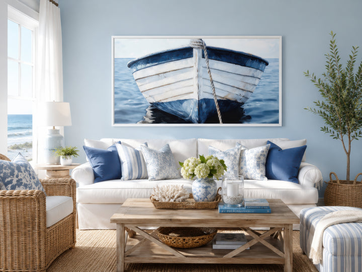 Framed rustic blue and white boat canvas wall art in a coastal-style living room.