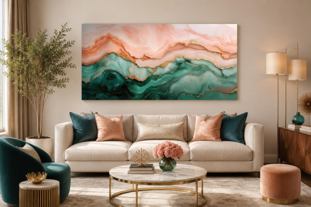 Blush pink and teal green abstract marble canvas wall art with gold veins above a beige sofa.