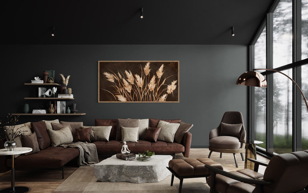 Boho canvas wall art featuring brown and beige grass in a rustic frame above a modern brown sofa.