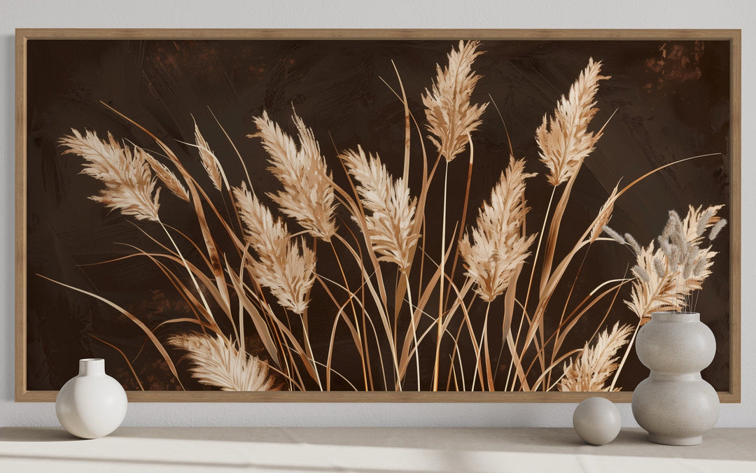 Boho framed canvas wall art featuring beige grass on a dark brown background in a rustic room.