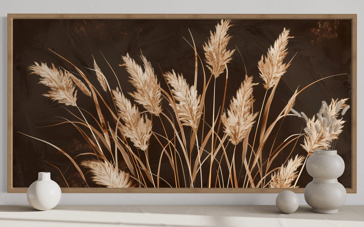 Boho framed canvas wall art featuring beige grass on a dark brown background in a rustic room.