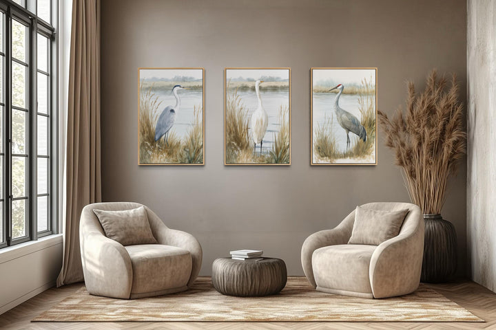 Three framed canvas prints of a heron, egret, and crane in a neutral, boho coastal living room.