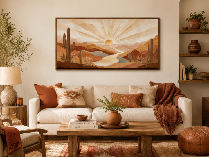 Boho desert sunset wall art featuring saguaro cacti and rolling hills in a warm, earthy living room.