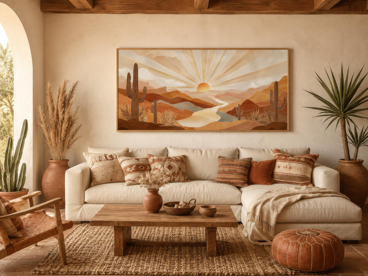 Boho desert sunset wall art featuring saguaro cacti and rolling hills in a warm living room.