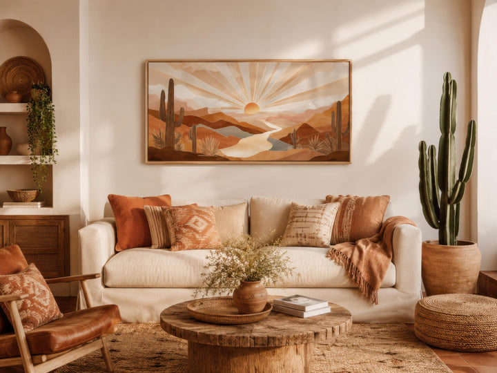 Boho desert sunset wall art featuring saguaro cacti and rolling hills in a warm, earthy living room.