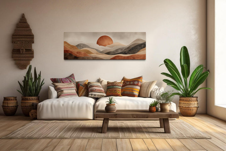 Long horizontal canvas print of a boho desert landscape with a terracotta sun above rolling hills.