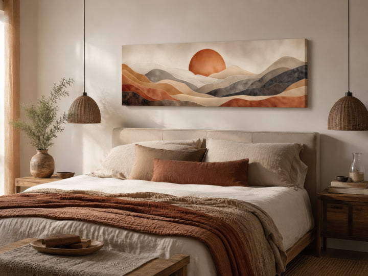 Long horizontal boho desert landscape canvas print with a terracotta sun above a bed.