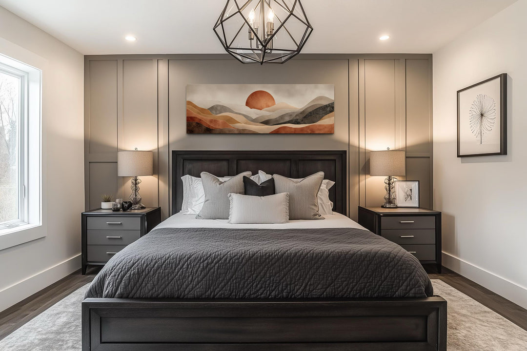 Boho desert landscape canvas wall art with terracotta sun above a dark wood bed in a modern bedroom.