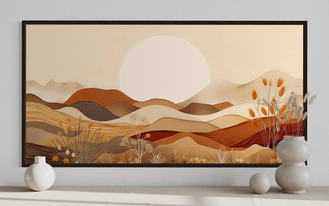 Framed boho desert landscape canvas art with rolling dunes and mountains in neutral earth tones.
