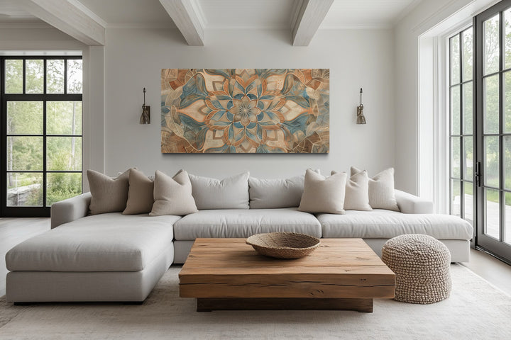 Large framed boho mandala canvas wall art in blue and beige tones above a neutral sofa.