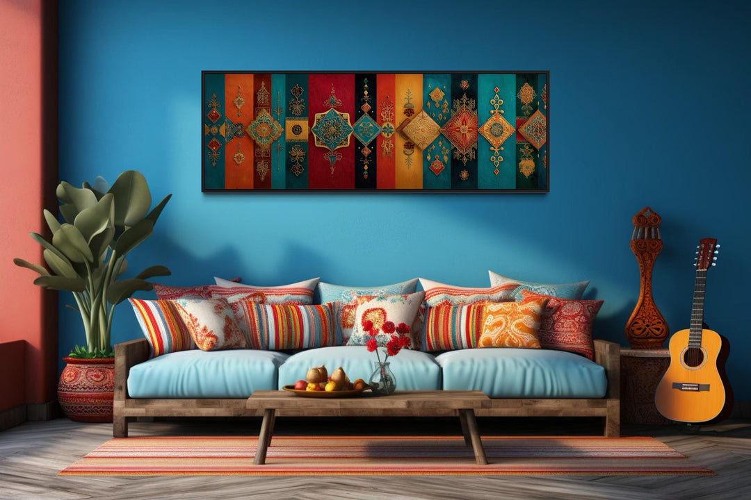 Boho Moroccan long horizontal colorful geometric wall art above a blue sofa with patterned pillows.