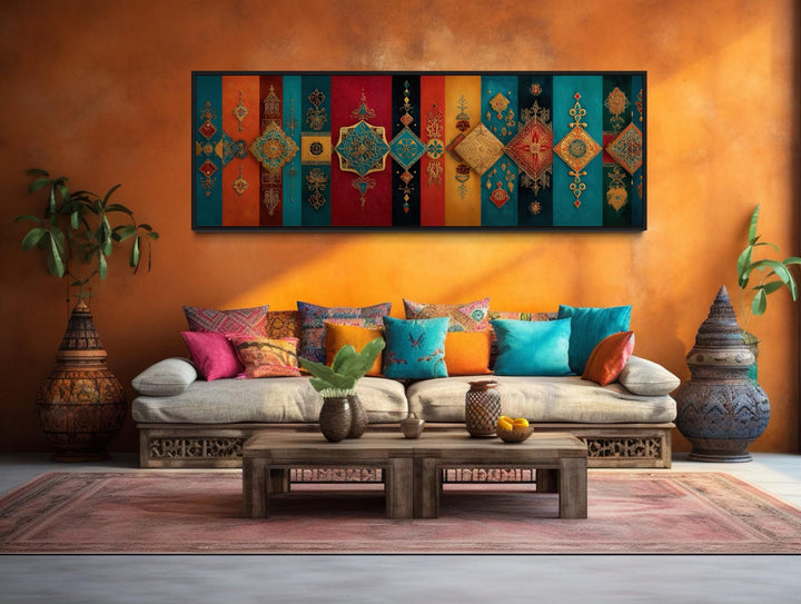 Boho Moroccan long horizontal colorful geometric wall art above a sofa with vibrant pillows.