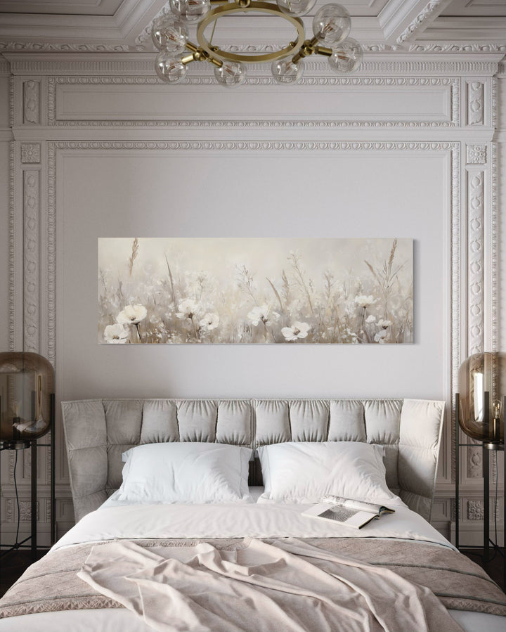 A long horizontal canvas of neutral-toned wildflowers hangs above a bed in a classic bedroom.