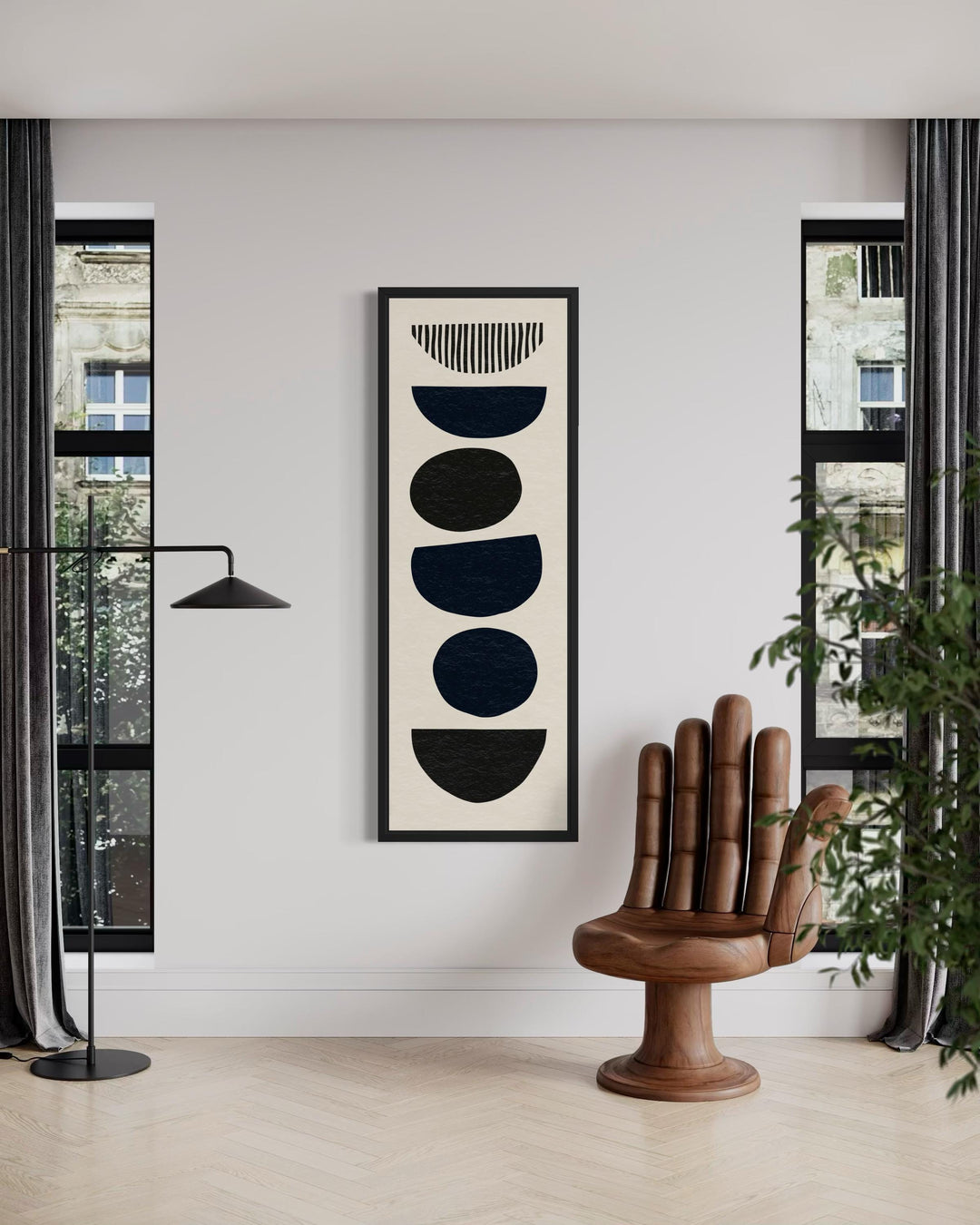 Tall narrow canvas wall art featuring black abstract stacked shapes in a black frame.