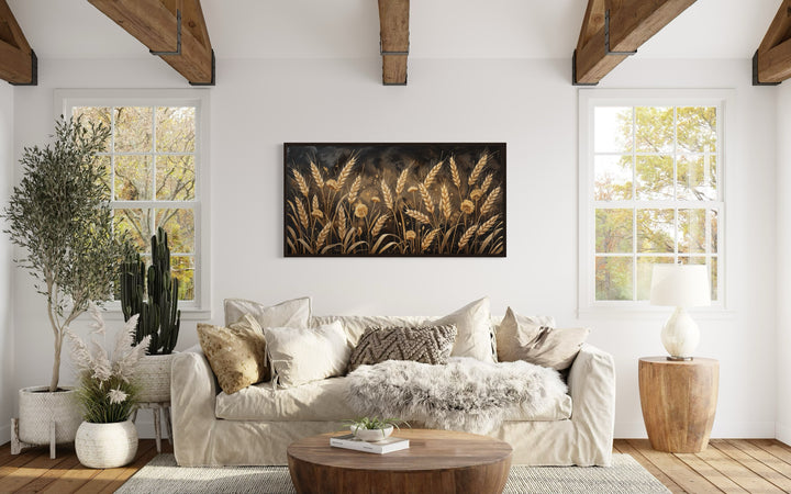 Boho wheat field framed canvas print in a rustic living room with neutral decor and wooden beams.