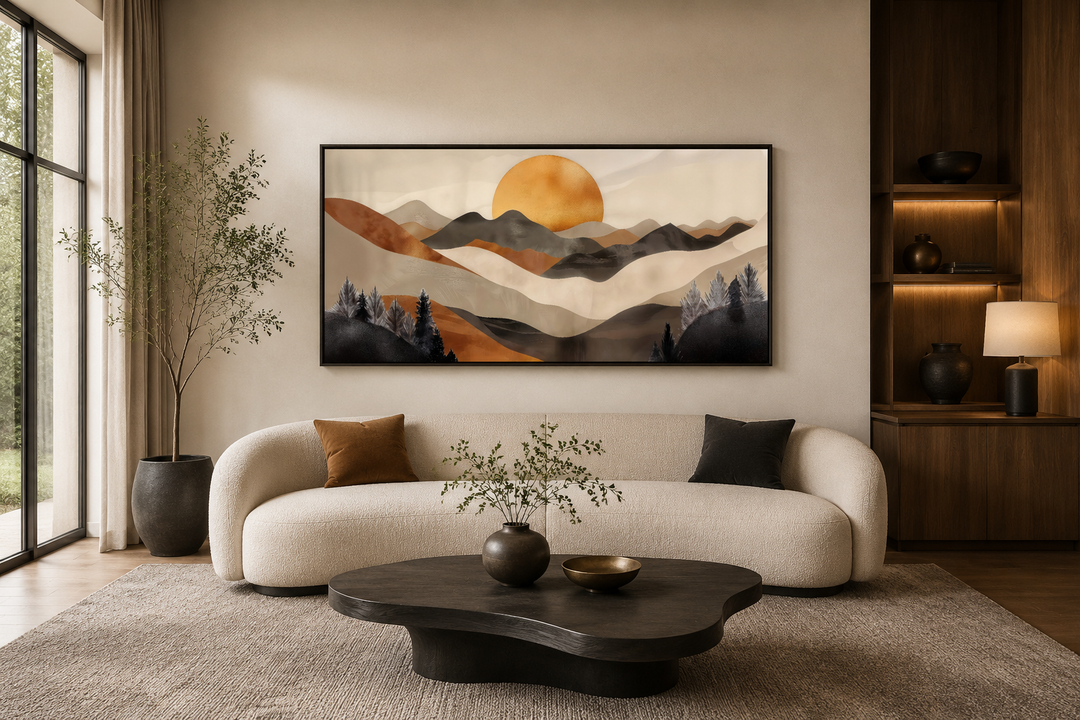 Boho mountain and sun framed canvas wall art in brown and beige earth tones above a cream sofa.