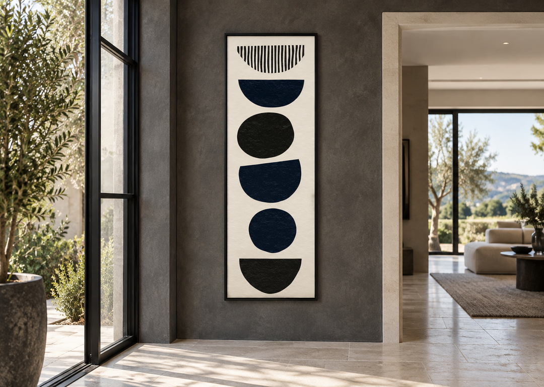 Tall narrow canvas wall art with black abstract stacked stone shapes on a cream background.