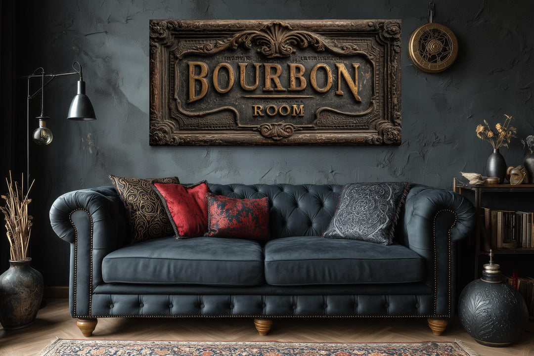 Bourbon Room wall art canvas print above a dark blue tufted sofa in a rustic man cave.