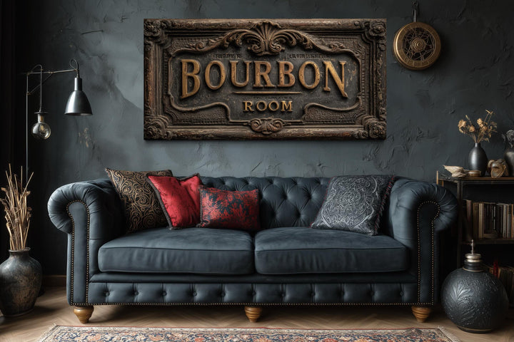Bourbon Room wall art canvas print above a dark blue tufted sofa in a rustic man cave.