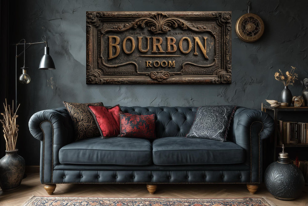 Bourbon Room wall art canvas print above a dark blue tufted sofa in a rustic man cave.
