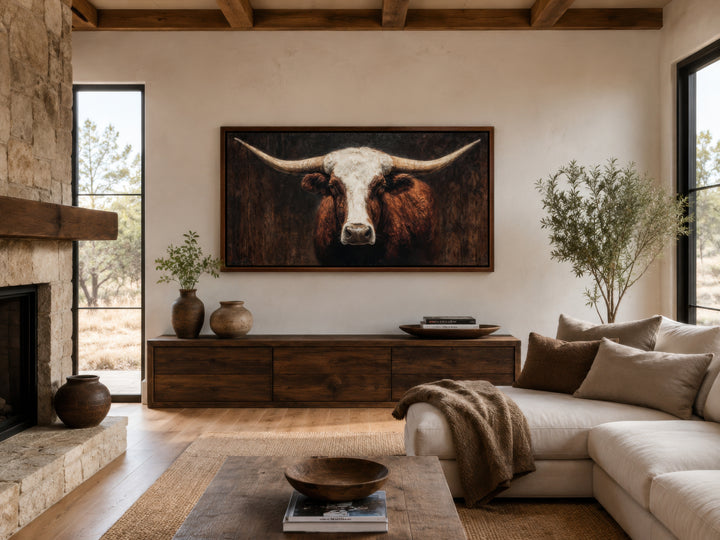 Extra large canvas wall art featuring a brown and white Texas longhorn bull in a rustic living room.