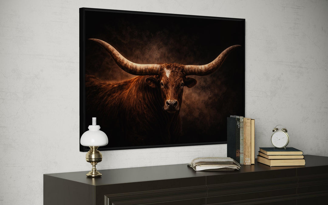 Brown longhorn bull canvas wall art with wide horns displayed above a dark wood dresser.