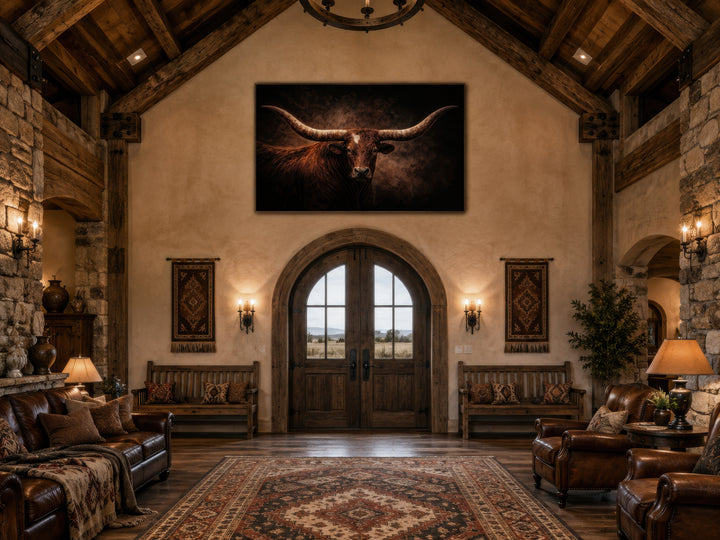 Brown longhorn bull canvas wall art hanging above a wooden arched door in a rustic ranch living room.