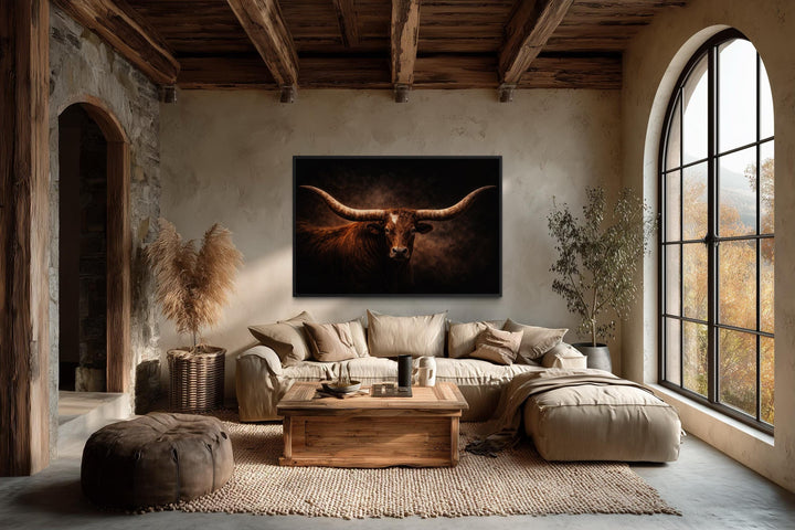 Brown longhorn bull canvas wall art hanging above a sofa in a rustic western living room.