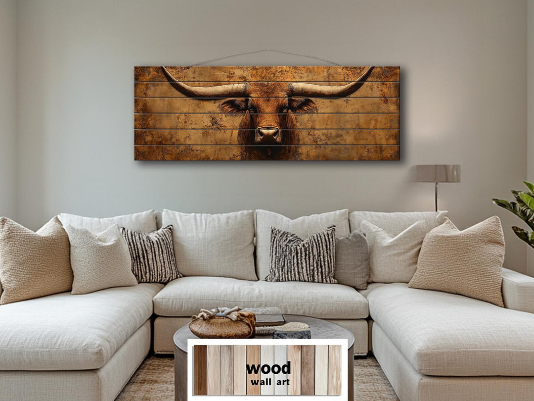 Brown longhorn steer printed on horizontal distressed wood planks above a white sectional sofa.