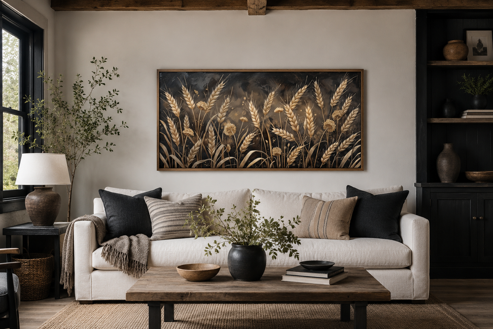 Framed horizontal canvas print of a boho wheat field in rustic brown and beige over a white sofa.