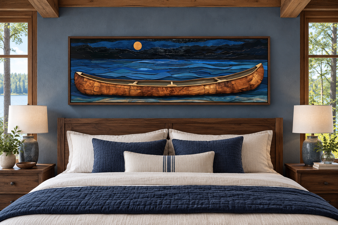 Long horizontal wall art of a brown canoe on a navy blue lake at night above a bed in a cabin.