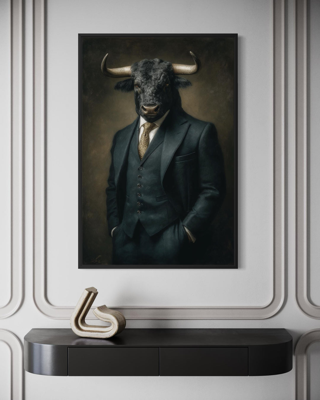 Framed canvas wall art of a bull in a dark three-piece suit hanging on a white paneled wall.