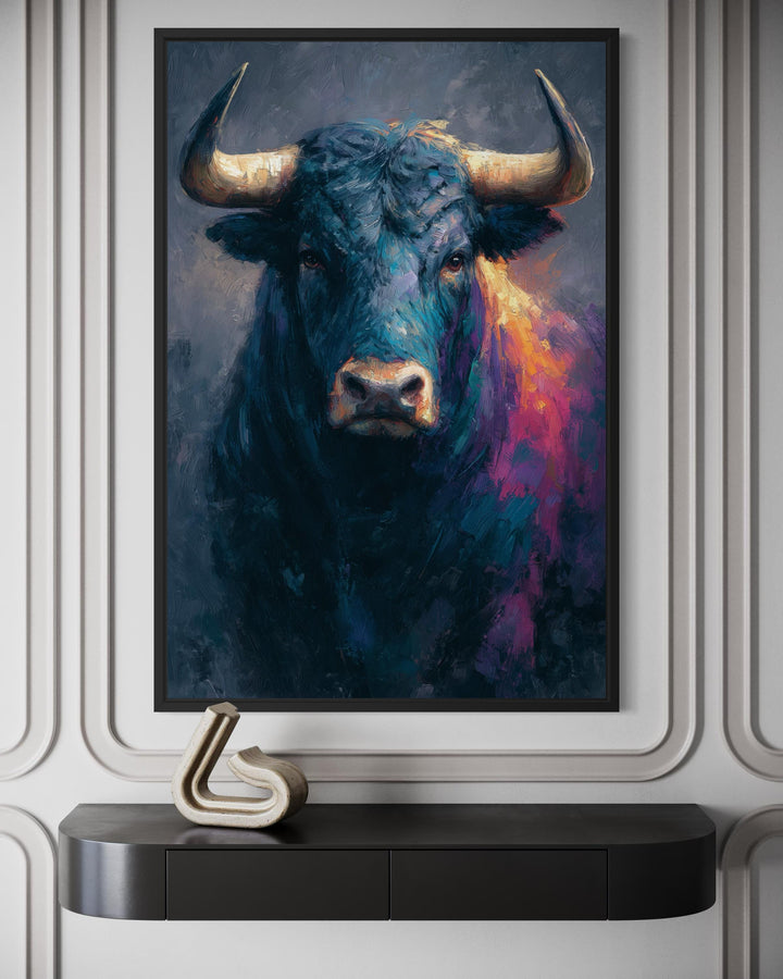 A framed modern canvas painting of a powerful bull with vibrant blue and pink brushstrokes.