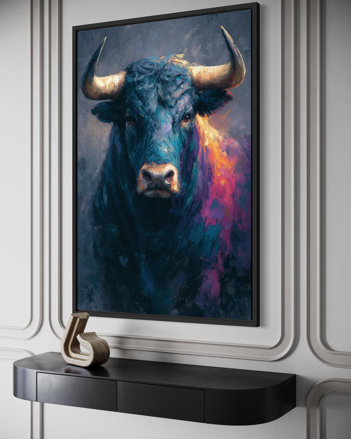 Modern bull painting canvas with bold colors and textures in a black frame on a paneled wall.