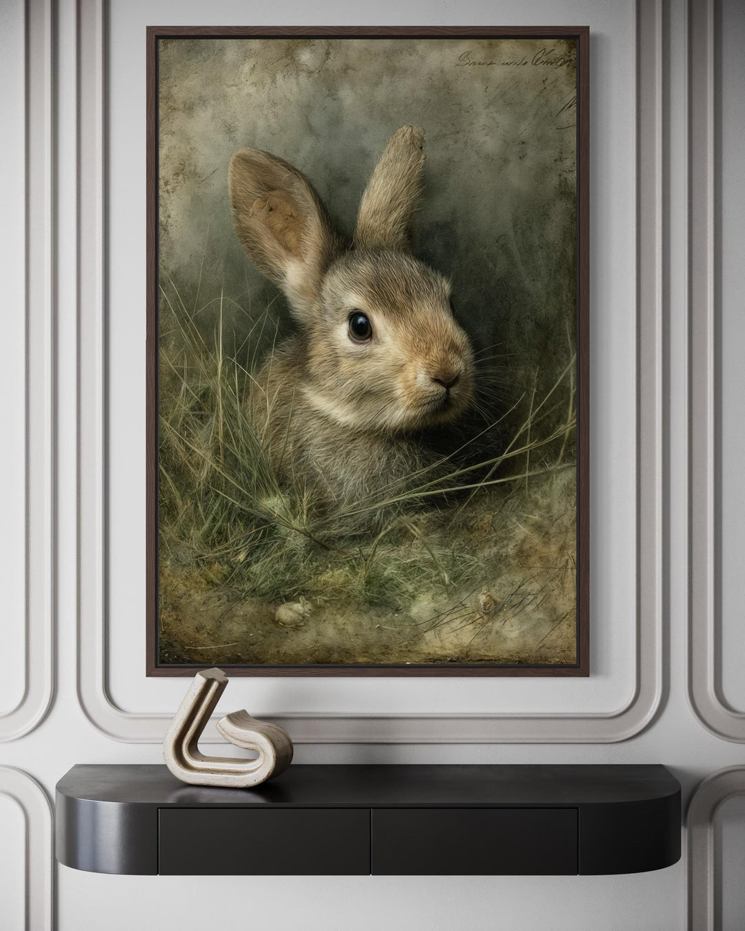 Vintage rabbit portrait canvas wall art in a dark wood frame above a modern black console table.