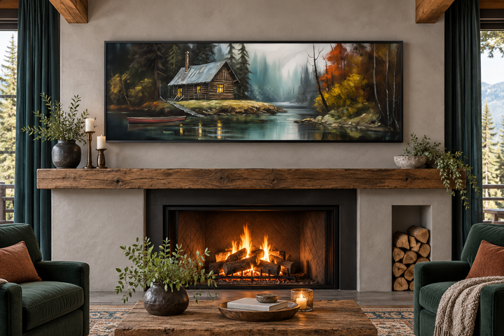 Narrow rustic framed canvas wall art of a cabin on a lake, hanging above a cozy fireplace.