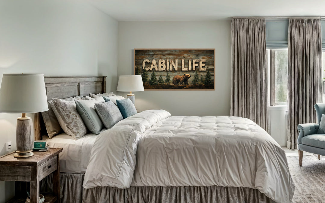 Cabin Life Sign With Bear And Fir Trees Framed Canvas Wall Art hanging above a bed in a bedroom.