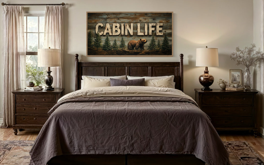 Cabin Life Sign With Bear And Fir Trees Framed Canvas Wall Art hanging above a bed in a bedroom.