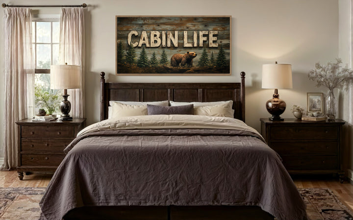 Cabin Life Sign With Bear And Fir Trees Framed Canvas Wall Art hanging above a bed in a bedroom.