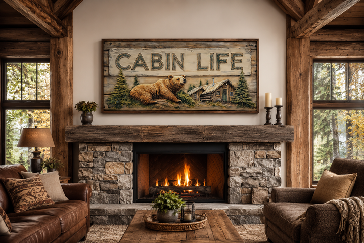 Framed canvas wall art featuring a bear, log cabin, and 'CABIN LIFE' text above a stone fireplace.
