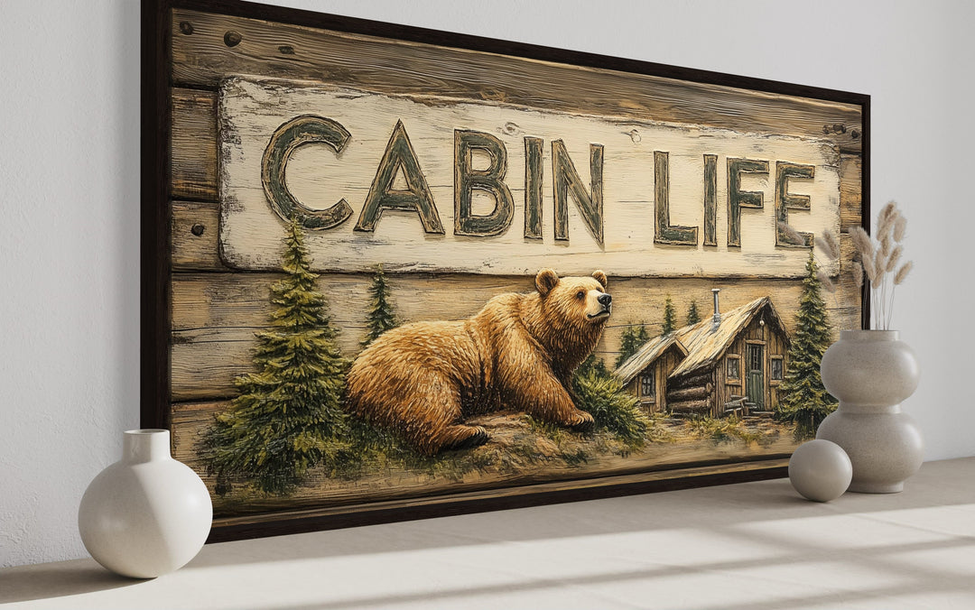 Cabin Life framed canvas wall art featuring a bear, log house, and rustic woodgrain design.