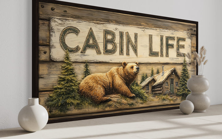 Cabin Life framed canvas wall art featuring a bear, log house, and rustic woodgrain design.