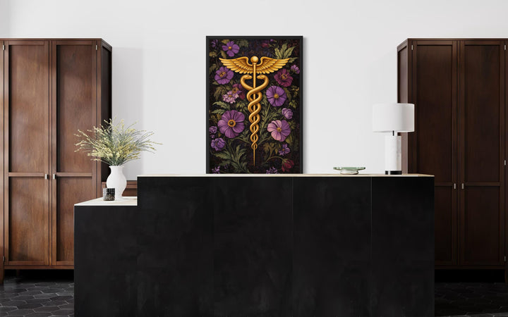 Nurse station wall decor - Caduceus medical wall art featuring a golden staff and purple flowers in a dark framed canvas.