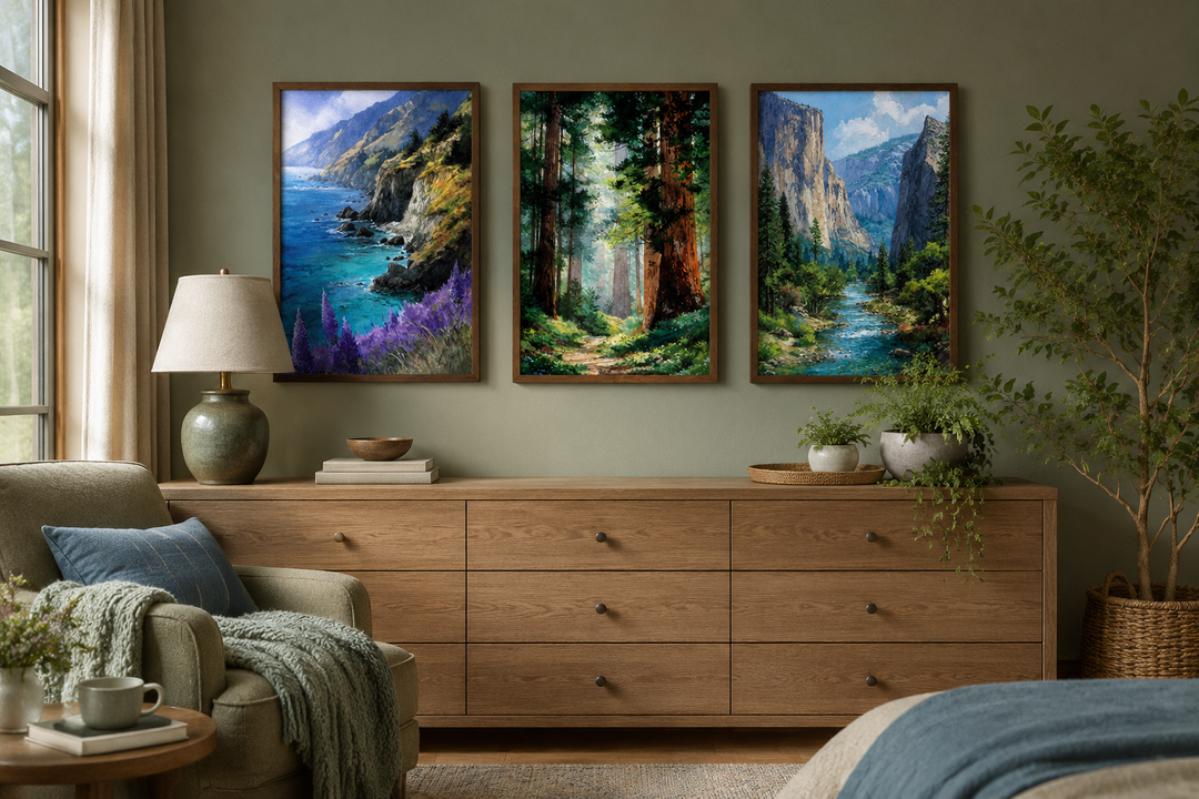 Set of 3 framed California landscape paintings of Big Sur, Redwood Forest, and Yosemite on a wall.