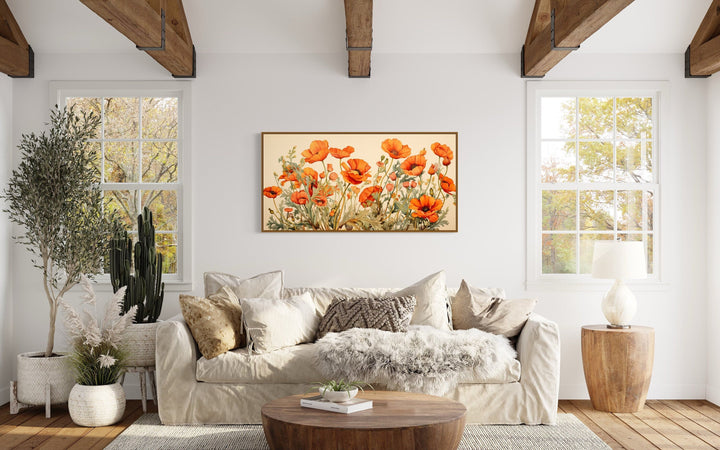 California Poppies Framed Canvas Wall Art featuring orange blooms above a neutral sofa.