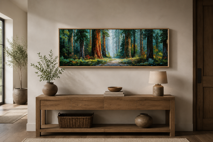Long horizontal canvas wall art of a California redwood forest above a wooden console table.
