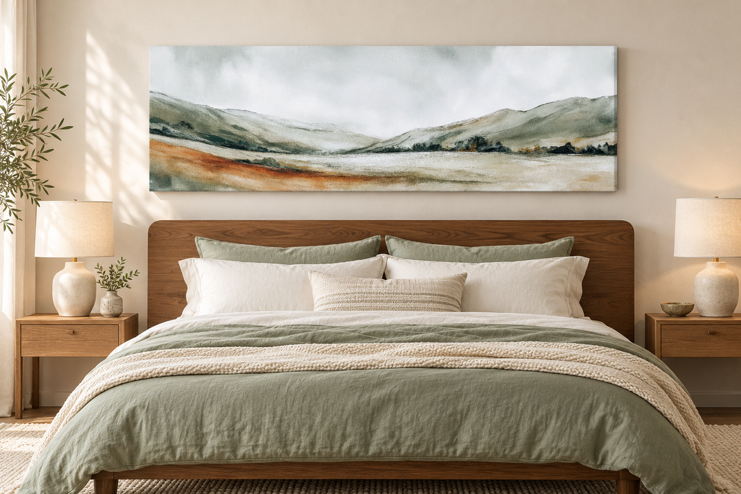 Panoramic green landscape canvas print above a bed with sage green bedding and wooden nightstands.