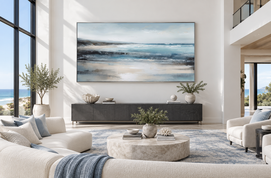 Large framed minimalist blue and gray ocean abstract canvas wall art above a dark wood sideboard.