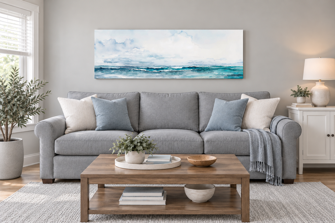 Minimalist ocean blue and gray horizontal framed canvas wall art hanging above a gray sofa.