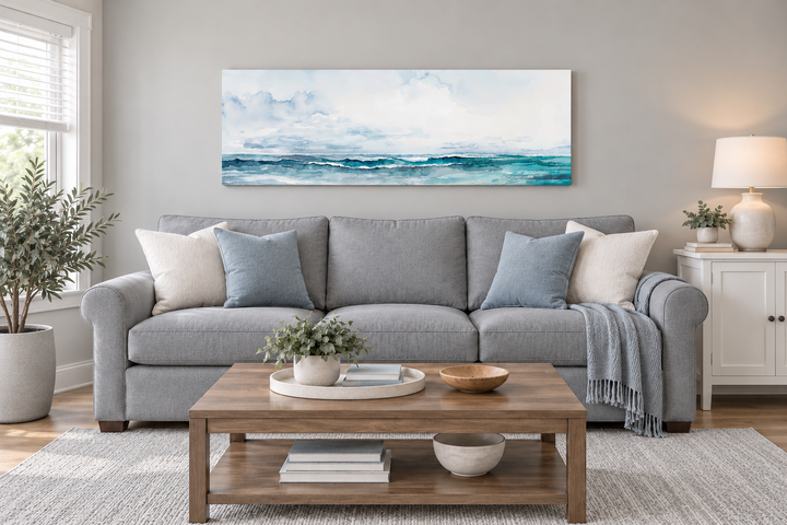 Minimalist ocean blue and gray horizontal framed canvas wall art hanging above a gray sofa.
